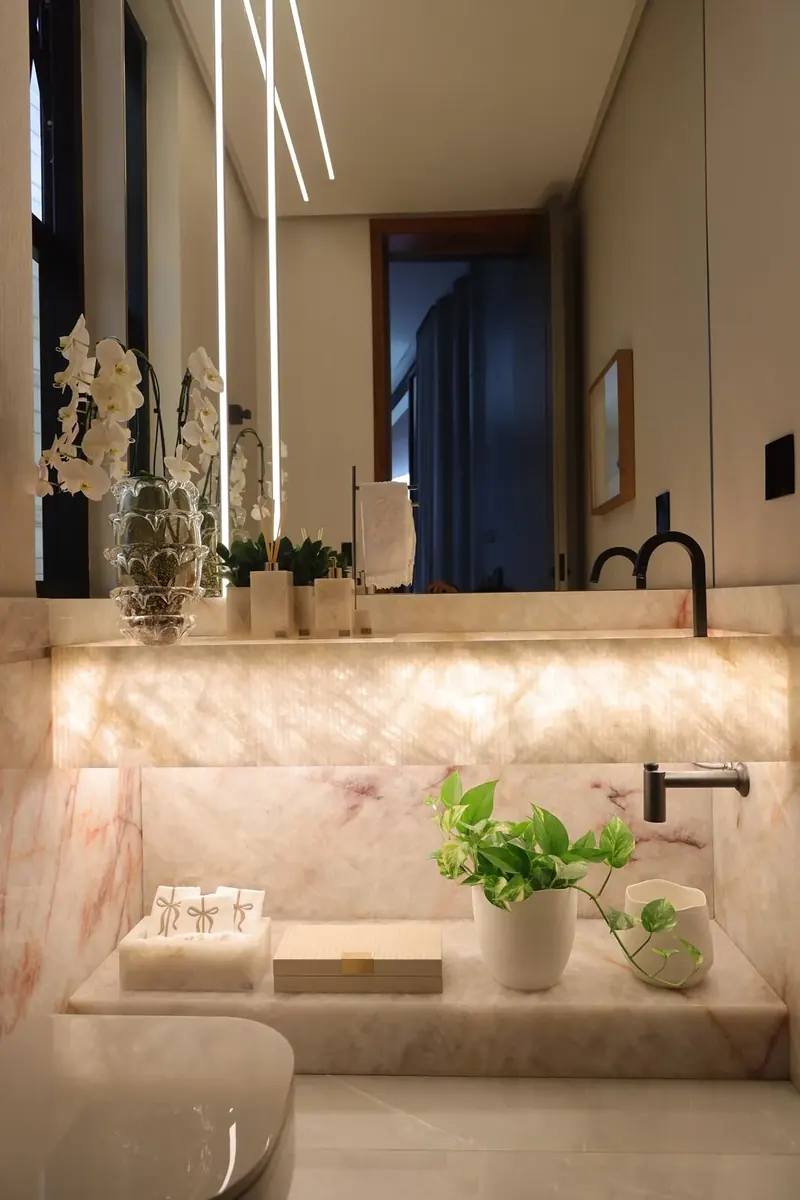 Lavabo em ônix com cuba esculpida e iluminação embutida